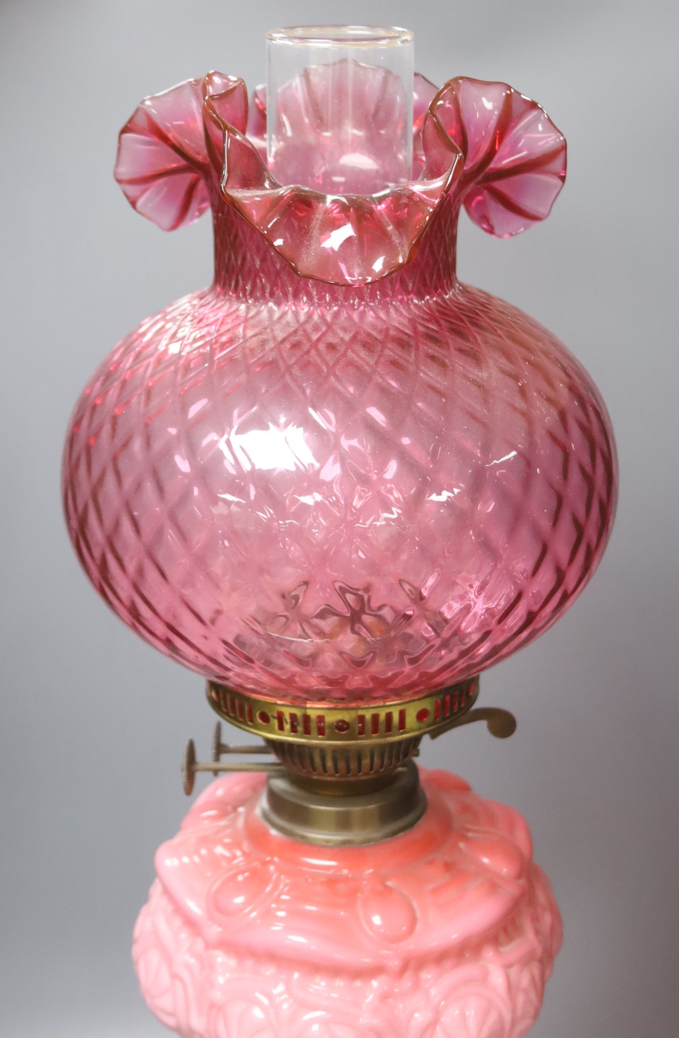 A Victorian brass and pink glass oil lamp, height 70cm